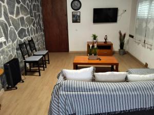a living room with two couches and a table at Casa Chemar in La Orotava