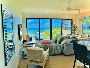 a living room with a view of the ocean at Oceanfront Residency luxury 2B2B ,1-6 person ,terrasse, beach access garden pool in Old Man Bay