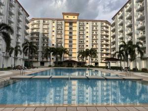 a large apartment building with a large swimming pool at SMDC Field REsidences condo unit in Manila