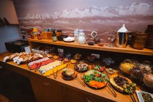 a buffet with many different types of food on a table at Vila Emma in Štrbské Pleso