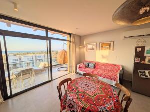a living room with a table and a balcony at Panoramic Seaview Somabay 1BR Apartment in Mesca in Hurghada