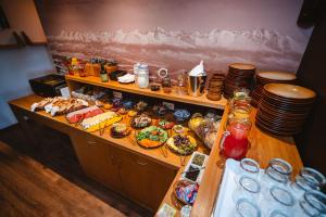a buffet with plates and food on a table at Vila Emma in Štrbské Pleso +22 photos