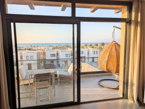 a view of a balcony with a table and chairs at Panoramic Seaview Somabay 1BR Apartment in Mesca in Hurghada +12 photos
