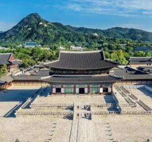 an asian building with a mountain in the background at Stay jongno238 in Seoul
