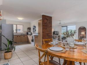 a kitchen and dining room with a table and chairs at Layback on Marine in Kingscliff
