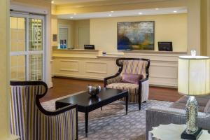 a lobby with a waiting area with two chairs and a table at Fairfield Inn by Marriott Boston Sudbury in Sudbury
