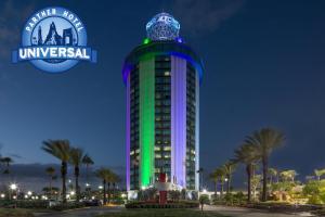 a building that is lit up in green and purple at Four Points by Sheraton Orlando International Drive in Orlando