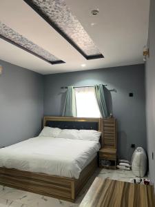 a bedroom with a bed and a window at GG suites and Apartments in Owerri +24 photos