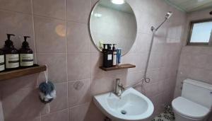 a bathroom with a sink and a mirror and a toilet at Stay jongno238 in Seoul +60 photos