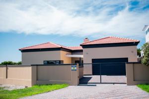 a house with a gate in front of it at Santareme Breeze in Sea Vista