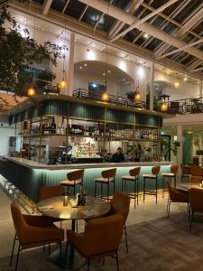 a restaurant with tables and chairs and a bar at Hotel Alte Post Flensburg in Flensburg