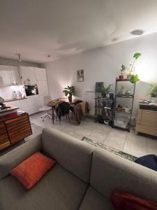 a living room with a couch and a table at Cozy personal flat in Differdange in Differdange