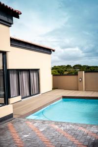 a swimming pool in the backyard of a house at Santareme Breeze in Sea Vista
