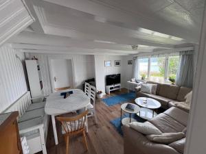 a living room with a couch and a table at House with Whirlpool in Nygard