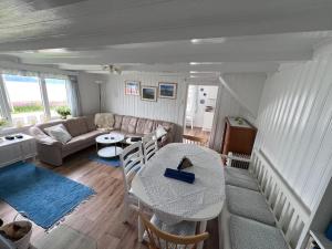 a living room with a table and a couch at House with Whirlpool in Nygard