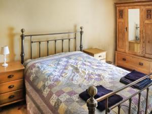 a bedroom with a bed and a dresser at Farm House - Uk50262 in Llandeilo