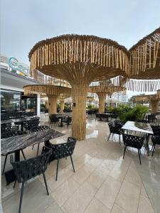 a pavilion with tables and chairs in a restaurant at Blue Studios by Comfort Suites in Golem