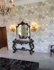 a dressing table with a mirror on a wall at Schloss Schmuggerow in Schmuggerow