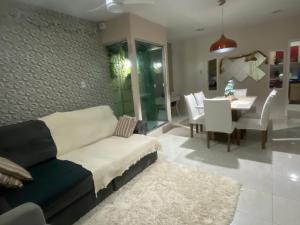 a living room with a couch and a dining room at Grande casa para COP30 perto do parque da cidade in Belém