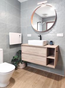 a bathroom with a sink and a mirror at l'Alqueria de Laguar - Casa rural al Barranc de l'Infern in Benimaurell +45 photos