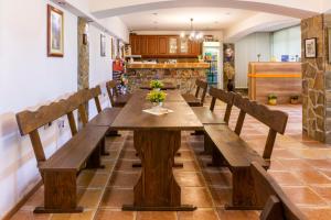 a long wooden table in a room with benches at Todorovi Guest House in Stara Zagora
