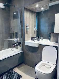 a bathroom with a toilet and a sink and a shower at Cozy Bedroom in a Townhouse Next to Jewellery Quarters and City Centre in Birmingham