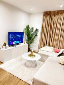 a living room with a couch and a tv at Cozy Bedroom in a Townhouse Next to Jewellery Quarters and City Centre in Birmingham