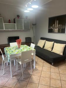 a living room with a table and a couch at Humanitas, Forum center Milano Trilo with Terrazzo in Rozzano