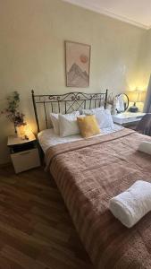 a bedroom with a large bed with white pillows at Home Boutique Hotel in Chişinău