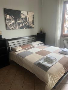 a bedroom with a bed with towels on it at Humanitas, Forum center Milano Trilo with Terrazzo in Rozzano