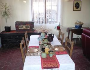 a dining room with two tables with dishes on them at Le Havre de Bennecourt in Bennecourt