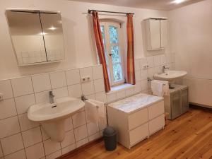 a white bathroom with a sink and a mirror at Landquartier Friesenhausen in Aidhausen +34 photos