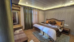 a bedroom with a large bed and a window at The White Mountain Stays in Kibar +23 photos