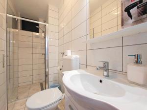 a white bathroom with a toilet and a sink at Robinson Monte Cristo in Bogomolje +38 photos