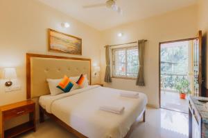 a bedroom with a large white bed and a window at Pvt Pool - Villa Azura Escape Marialina Calangute in Saligao +38 photos