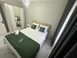 a small bedroom with a bed and a mirror at Royal Suit in Bandırma