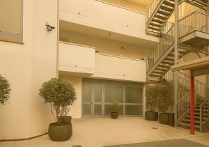 ミラノにあるSechi Hotel Milanoの階段と植物のある中庭