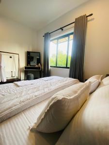 Postel nebo postele na pokoji v ubytování Villa Rowell