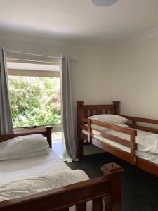 a bedroom with two bunk beds and a window at Govetts Leap lookout cottage with sauna in Blackheath