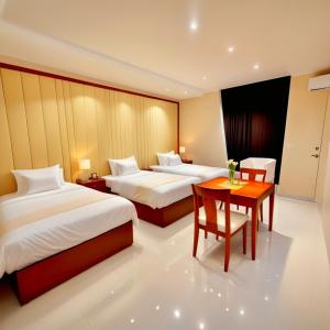 a hotel room with two beds and a table at Pyramids & SphinX Grand Hotel in Cairo