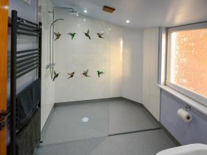 a small bathroom with birds on the wall at Uplands in Dalbeattie +4 photos