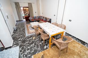 a living room with a table and chairs at Gentians Freedom House in Luxor