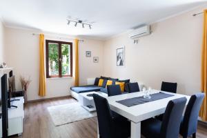 a living room with a table and a couch at Sele by Vintage Travel in Gruda