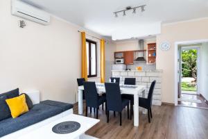 a living room and dining room with a table and chairs at Sele by Vintage Travel in Gruda