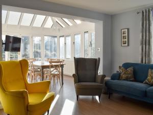 a living room with a couch and a table and chairs at Pines Cottage - Uk42110 in St Margarets at Cliff
