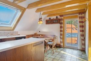 a kitchen with a table and a dining room at Vogtadeshof in Wolfach