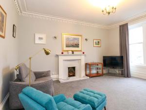 a living room with a couch and a fireplace at 9A Market Square in Stonehaven
