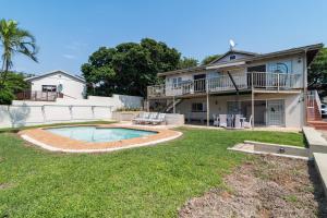 a backyard with a pool and a house at Jacqueline Drive 51 in Ballito
