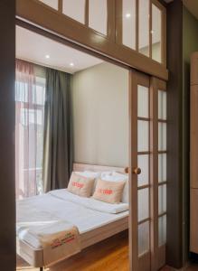 a bedroom with a canopy bed with white sheets and pillows at Apartment KeyGo #0201 next to the National Gallery in Yerevan +21 photos