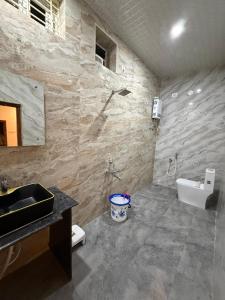 a bathroom with a sink and a toilet at shankar guest house in Hampi